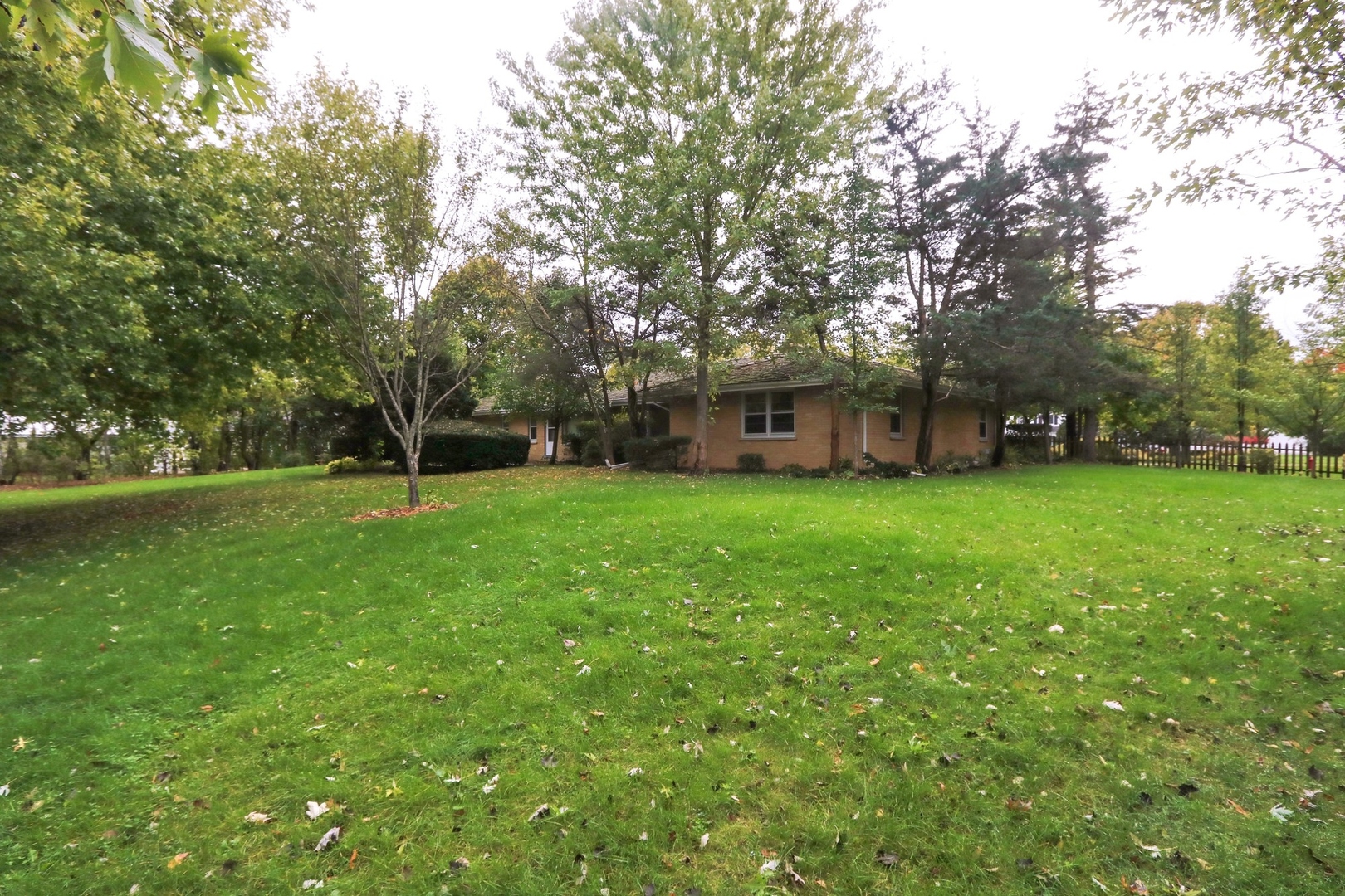 996 Castlegate Court Lake Forest, IL 60045 - Photo 10 of 10 a view of a house with a big yard and large trees