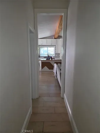 a view of a hallway view with wooden floor and furniture