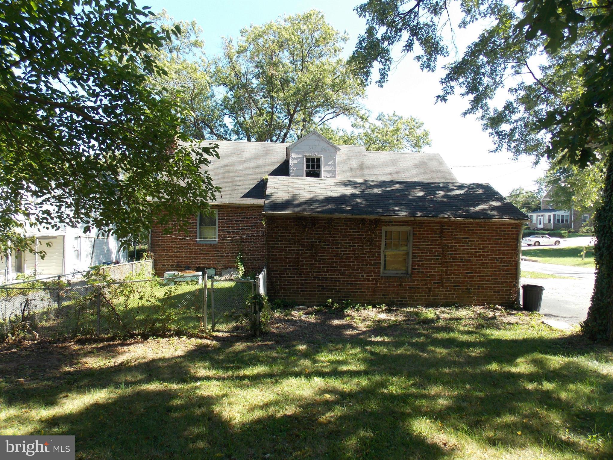 7700 Philadelphia Road Baltimore, MD 21237 - Photo 14 of 15 a view of a house with a yard and a large tree