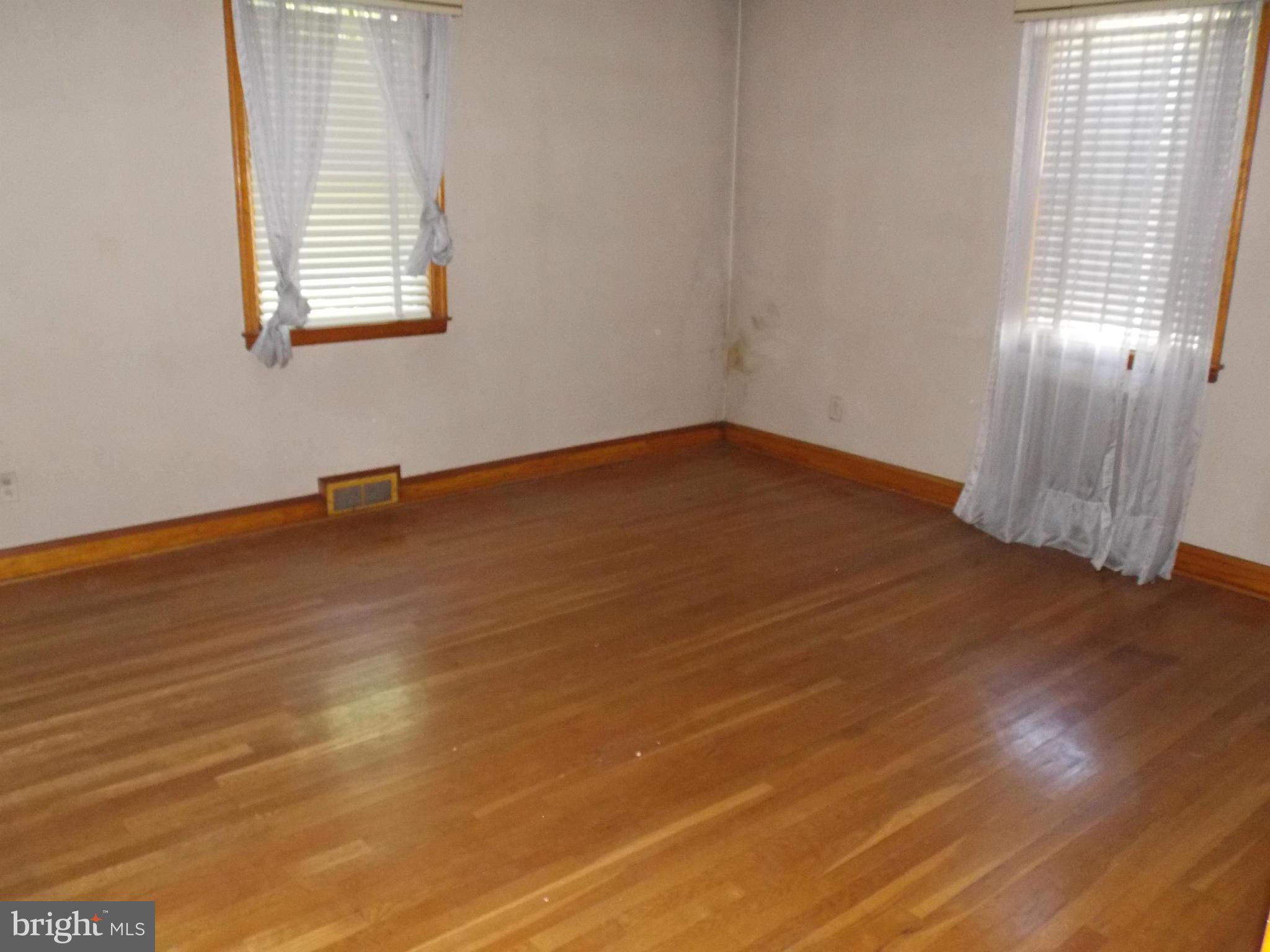 7700 Philadelphia Road Baltimore, MD 21237 - Photo 8 of 15 an empty room with wooden floor and windows
