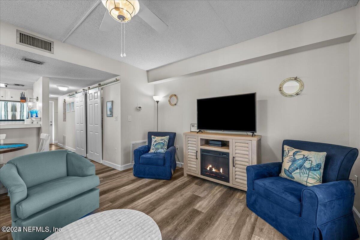 5930 Florida A1A, Unit 8E St. Augustine, FL 32080 - Photo 11 of 31 a living room with furniture and a flat screen tv