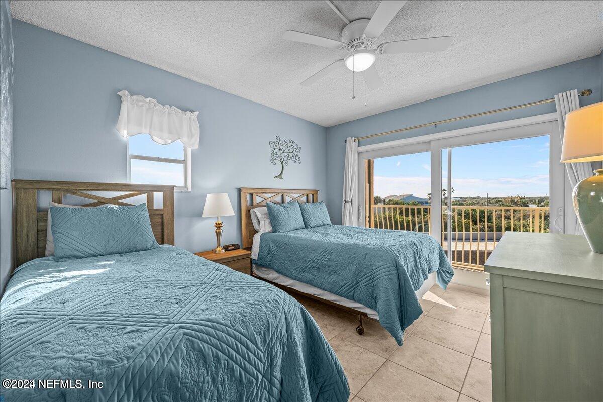 5930 Florida A1A, Unit 8E St. Augustine, FL 32080 - Photo 13 of 31 a bedroom with a large bed and a large window
