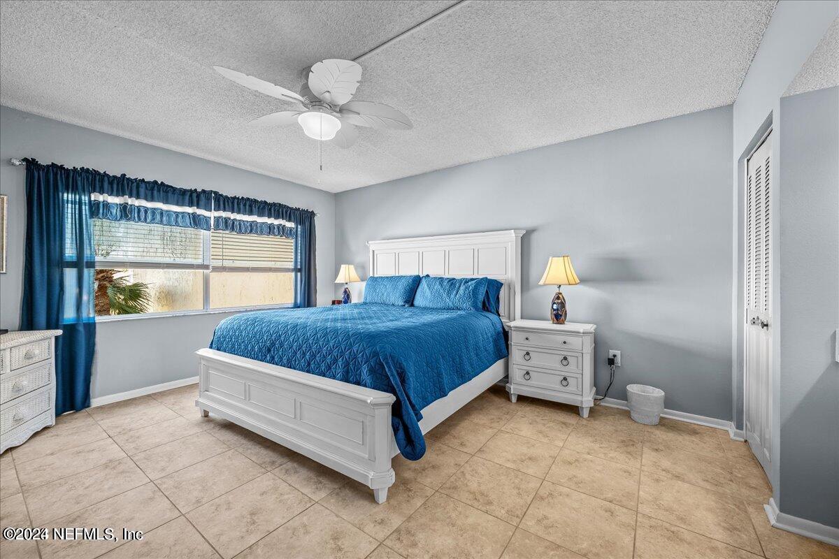 5930 Florida A1A, Unit 8E St. Augustine, FL 32080 - Photo 17 of 31 a spacious bedroom with a bed and a window