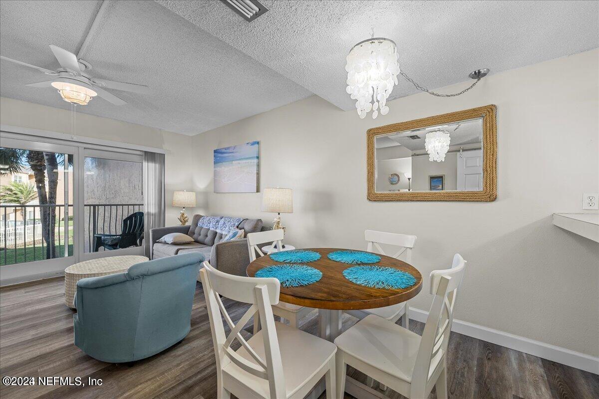 5930 Florida A1A, Unit 8E St. Augustine, FL 32080 - Photo 9 of 31 a view of a dining room with furniture large window and wooden floor