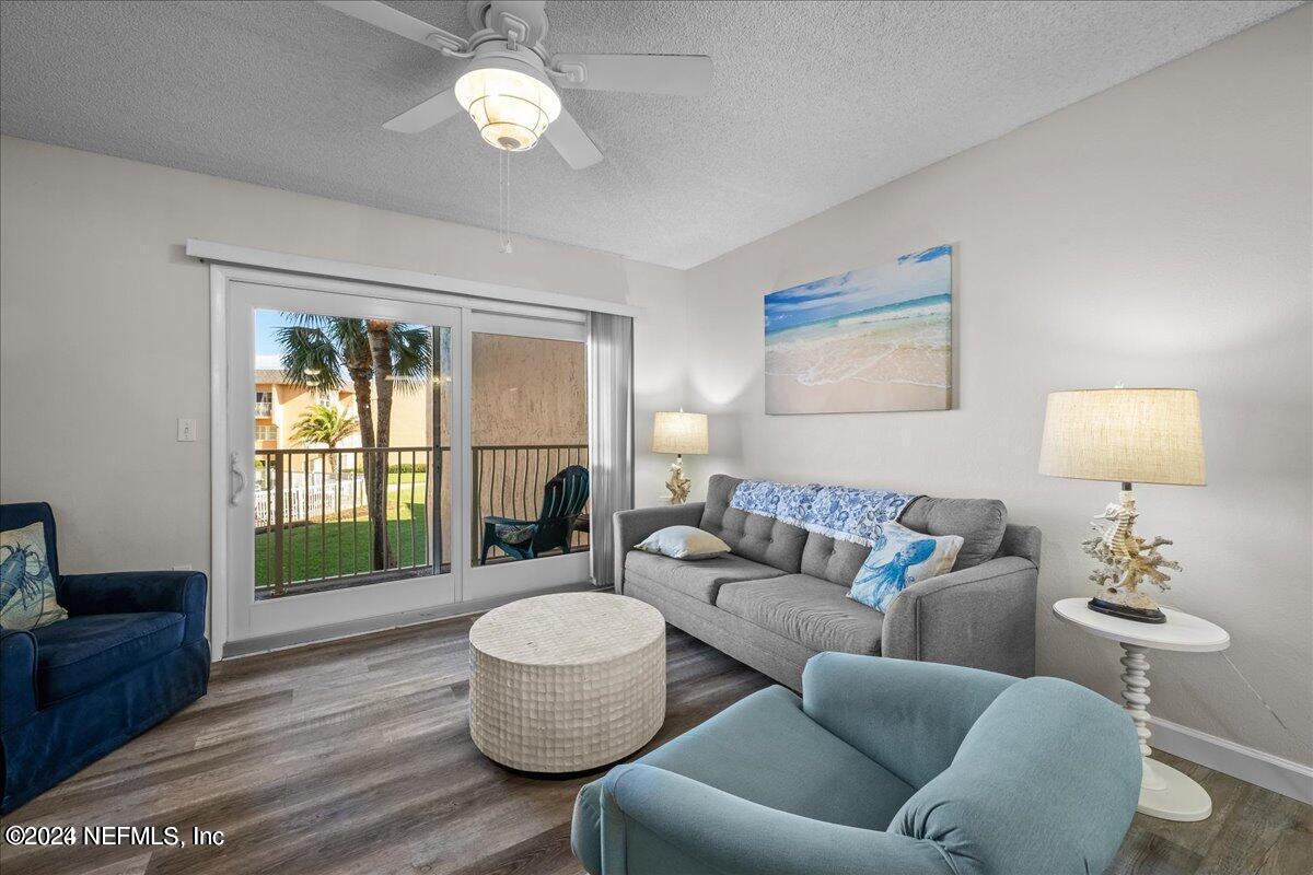 5930 Florida A1A, Unit 8E St. Augustine, FL 32080 - Photo 10 of 31 a living room with furniture chandelier and a window
