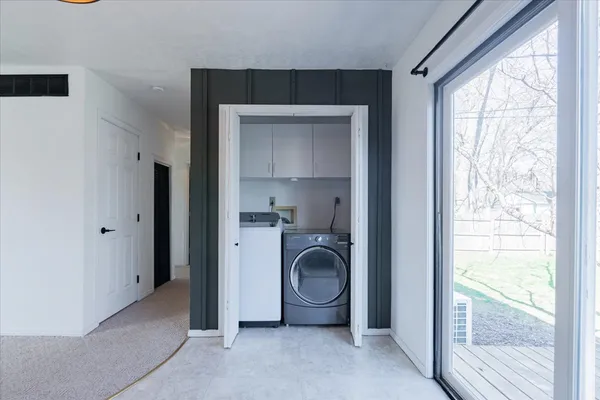 a view of a hallway with washer and dryer