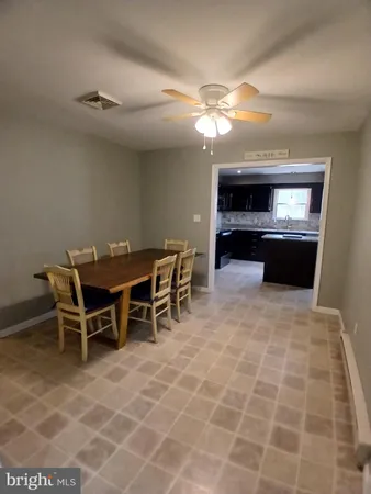 a view of a room with furniture and wooden floor