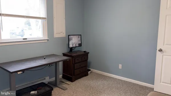 a view of a hallway with chairs and a table