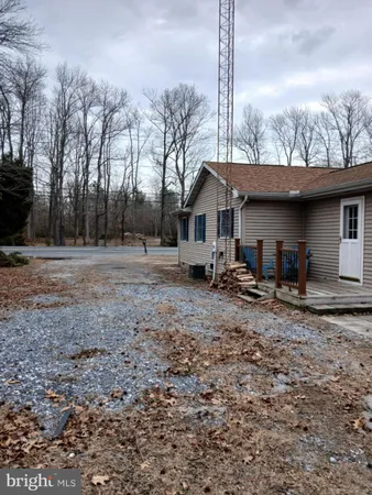 a front view of house with yard and trees