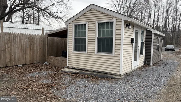 a view of a room with an empty space and wooden floor