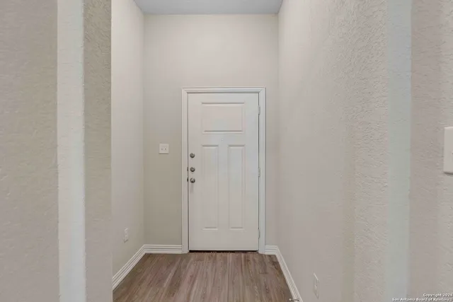 a view of a room with wooden floor