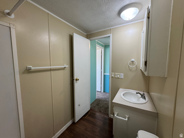 2491 Highway 89, Unit 315 Pleasant View, UT 84404 - Photo 32 of 34 Bathroom featuring wood-finish flooring and a ceiling-mounted light fixture