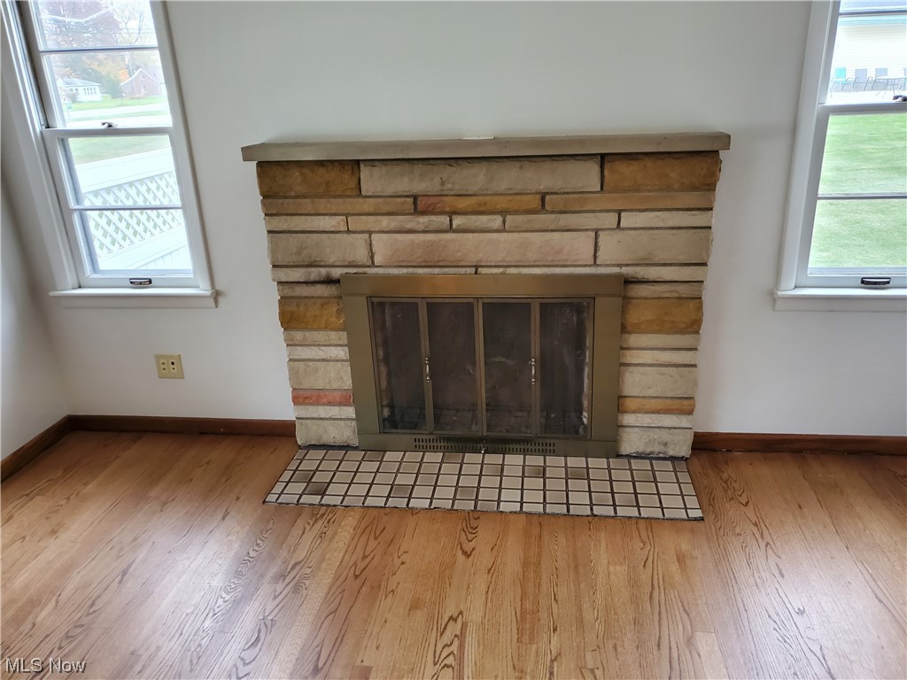 5530 Manchester Road Akron, OH 44319 - Photo 6 of 24 Details with a stone fireplace and light hardwood / wood-style flooring