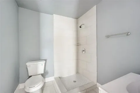 a white toilet sitting next to a bathroom sink
