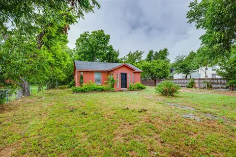 a front view of a house with yard and green space