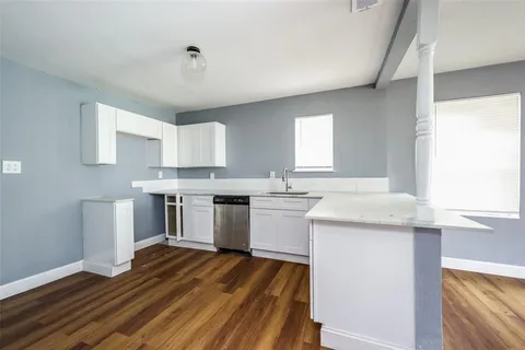 a kitchen with a sink stove and cabinets
