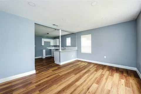 a view of a kitchen with wooden floor and a kitchen