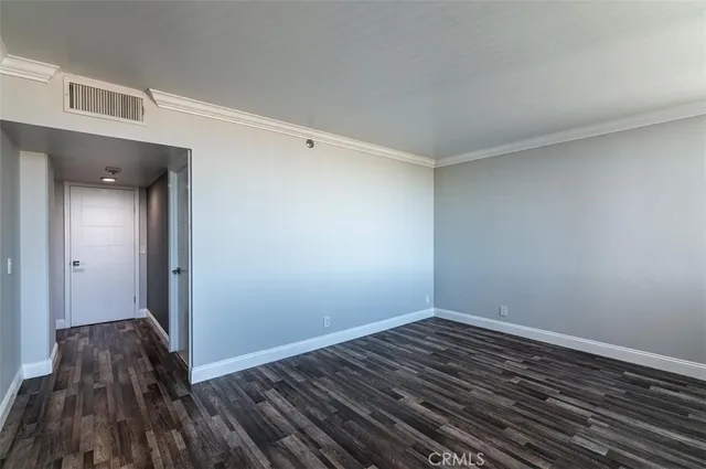 a view of a room with wooden floor and a window