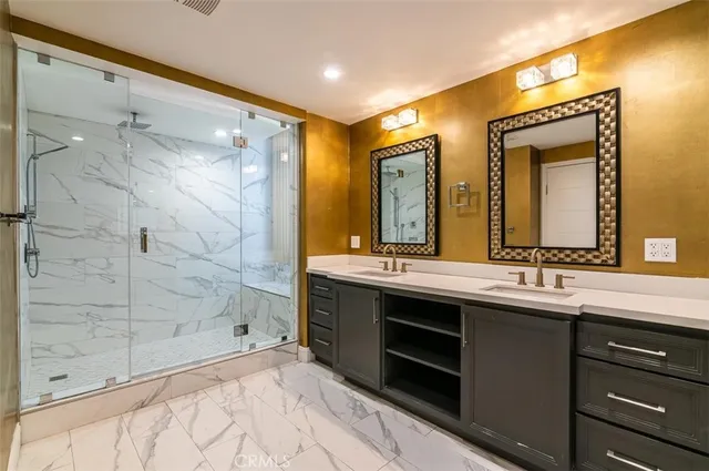 a bathroom with a double vanity sink mirror and shower