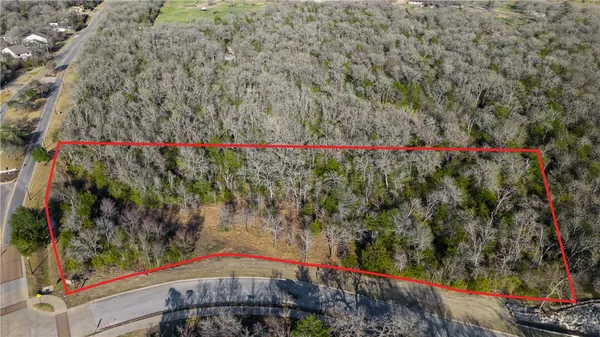 an aerial view of a house with a garden and lake view