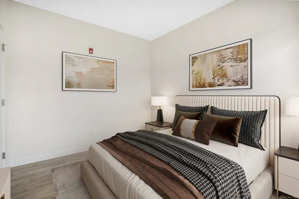 a bedroom with bed and cupboard