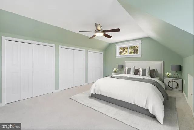 a bedroom with a bed and a ceiling fan