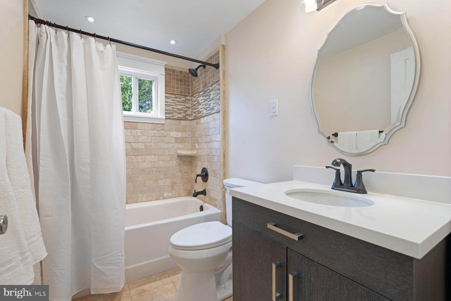27 Edgemoor Road Lutherville-Timonium, MD 21093 - Photo 22 of 42 a bathroom with a sink a toilet and shower