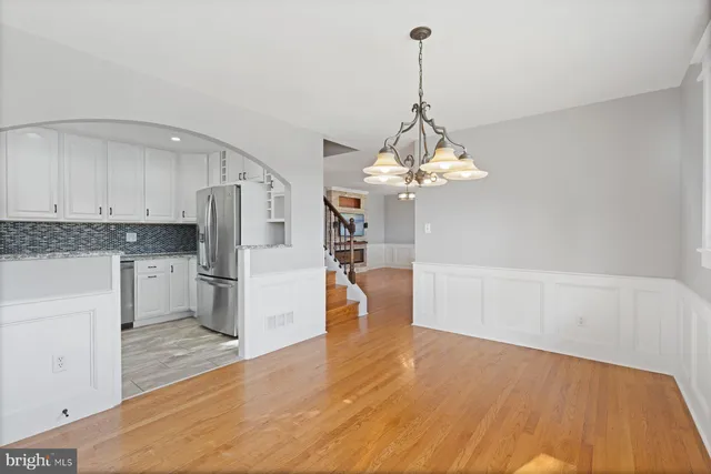 a view of a kitchen with a sink and refrigerator