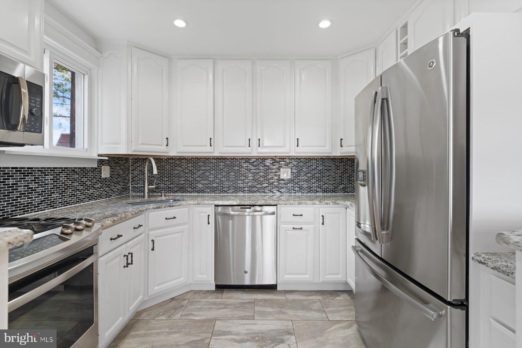 27 Edgemoor Road Lutherville-Timonium, MD 21093 - Photo 6 of 42 a kitchen with stainless steel appliances granite countertop a refrigerator sink and stove