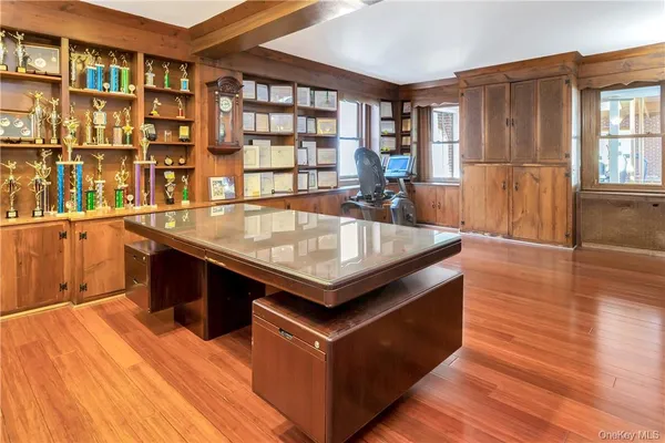 a living room with stainless steel appliances kitchen island granite countertop a table chairs and a large window