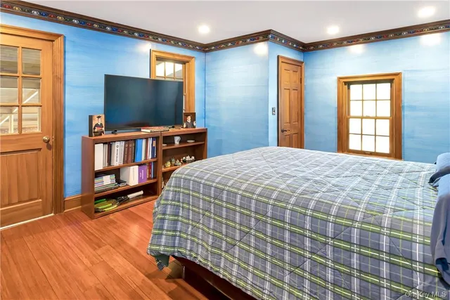 a bedroom with a bed and a flat screen tv