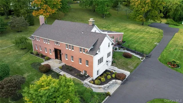an aerial view of a house with garden space and street view