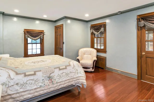 a spacious bedroom with a bed and a window