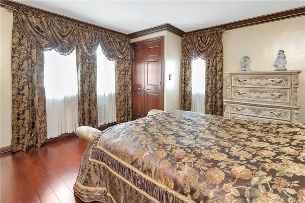 a bedroom with a large bed and a window