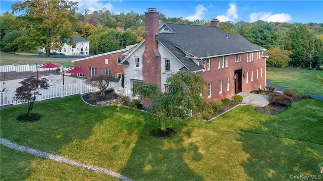 a aerial view of a house with a yard table and chairs