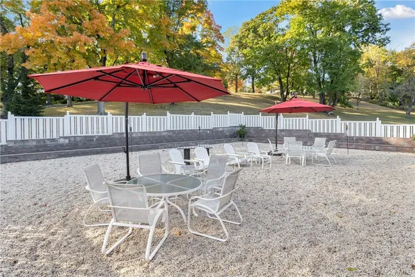 a view of a house with backyard and sitting area