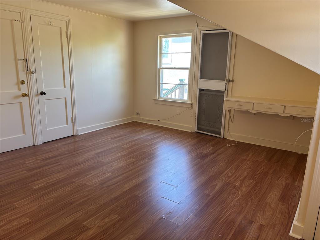 507 Cleveland Avenue Southwest, Unit 2 Largo, FL 33770 - Photo 11 of 20 an empty room with wooden floor and a window