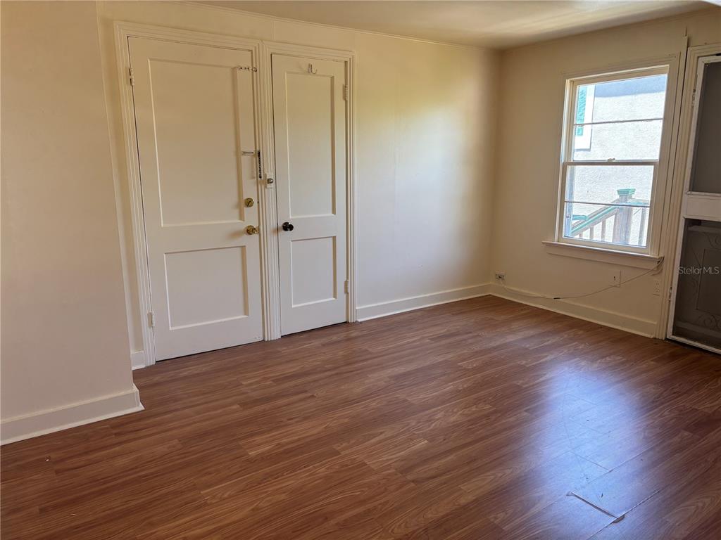 507 Cleveland Avenue Southwest, Unit 2 Largo, FL 33770 - Photo 12 of 20 a view of an empty room with wooden floor and a window