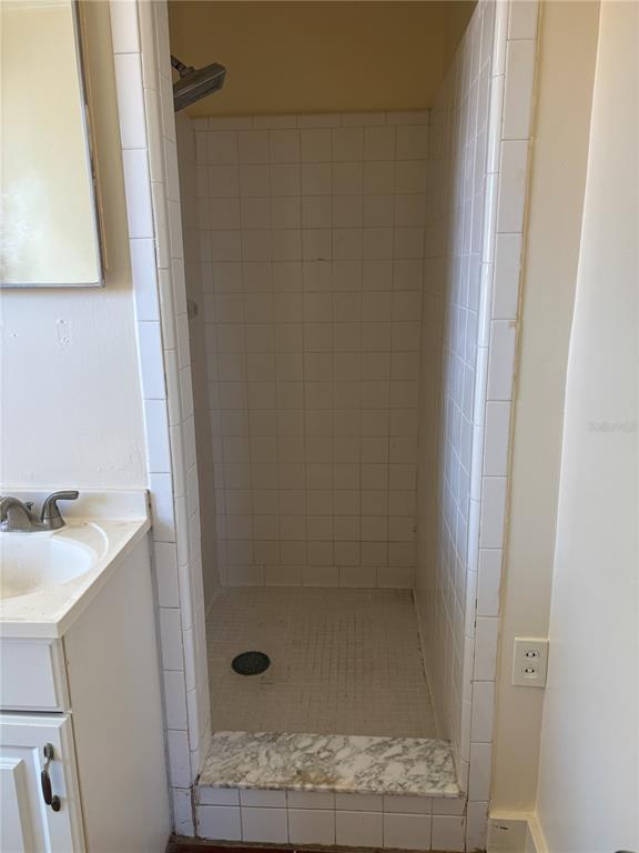 507 Cleveland Avenue Southwest, Unit 2 Largo, FL 33770 - Photo 15 of 20 a bathroom with a granite countertop sink a toilet and shower