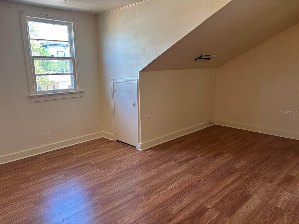 507 Cleveland Avenue Southwest, Unit 2 Largo, FL 33770 - Photo 3 of 20 an empty room with wooden floor and windows