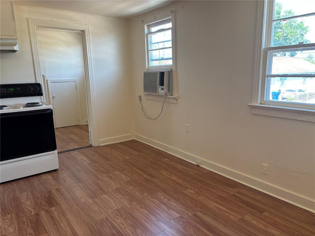 507 Cleveland Avenue Southwest, Unit 2 Largo, FL 33770 - Photo 4 of 20 an empty room with wooden floor and windows