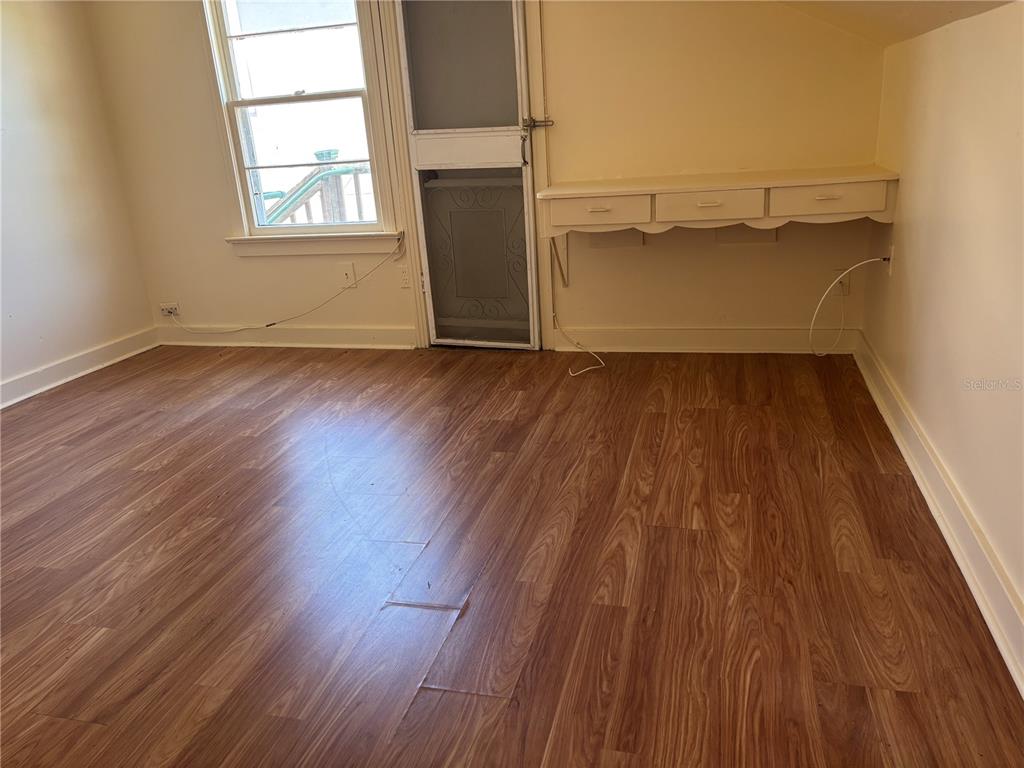 507 Cleveland Avenue Southwest, Unit 2 Largo, FL 33770 - Photo 9 of 20 an empty room with wooden floor and windows