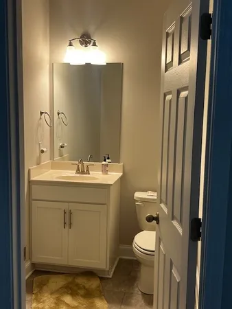 a bathroom with a toilet a sink and mirror