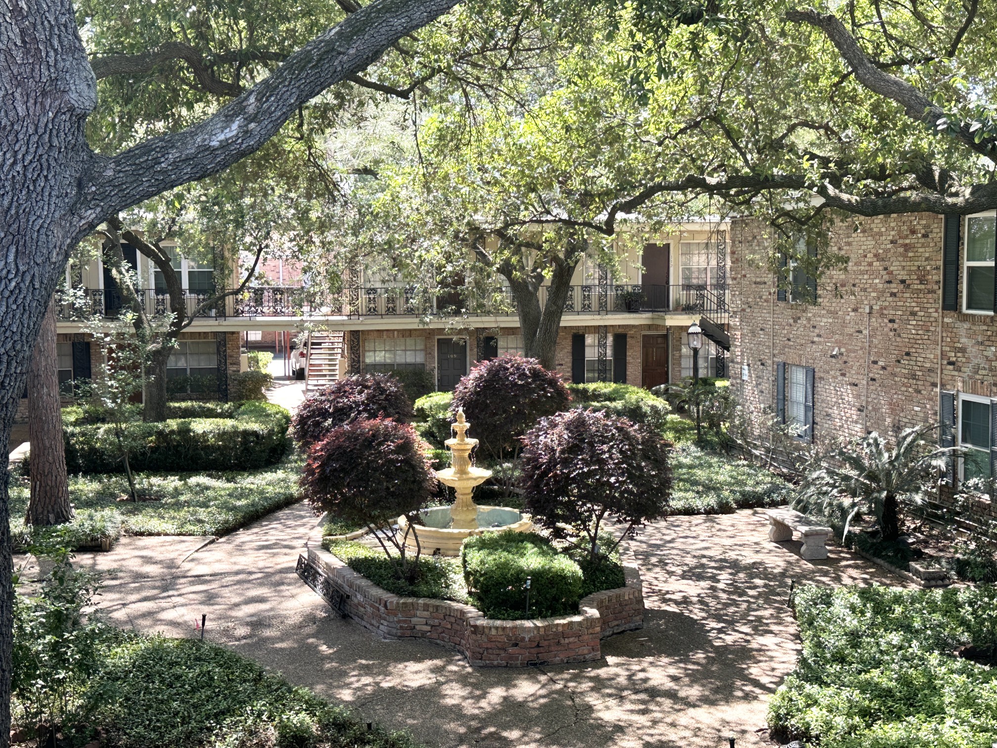 3224 Timmons Lane, Unit 154 Houston, TX 77027 - Photo 16 of 21 a front view of a house with a yard and a garden