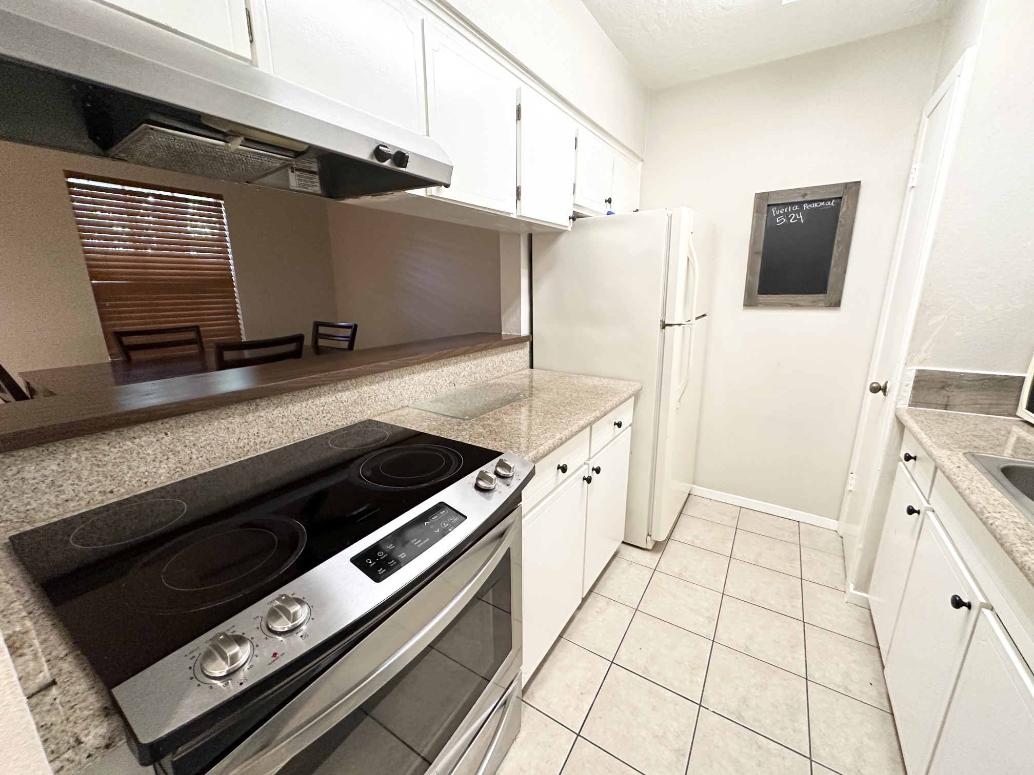 3224 Timmons Lane, Unit 154 Houston, TX 77027 - Photo 5 of 21 a kitchen with a stove and a microwave