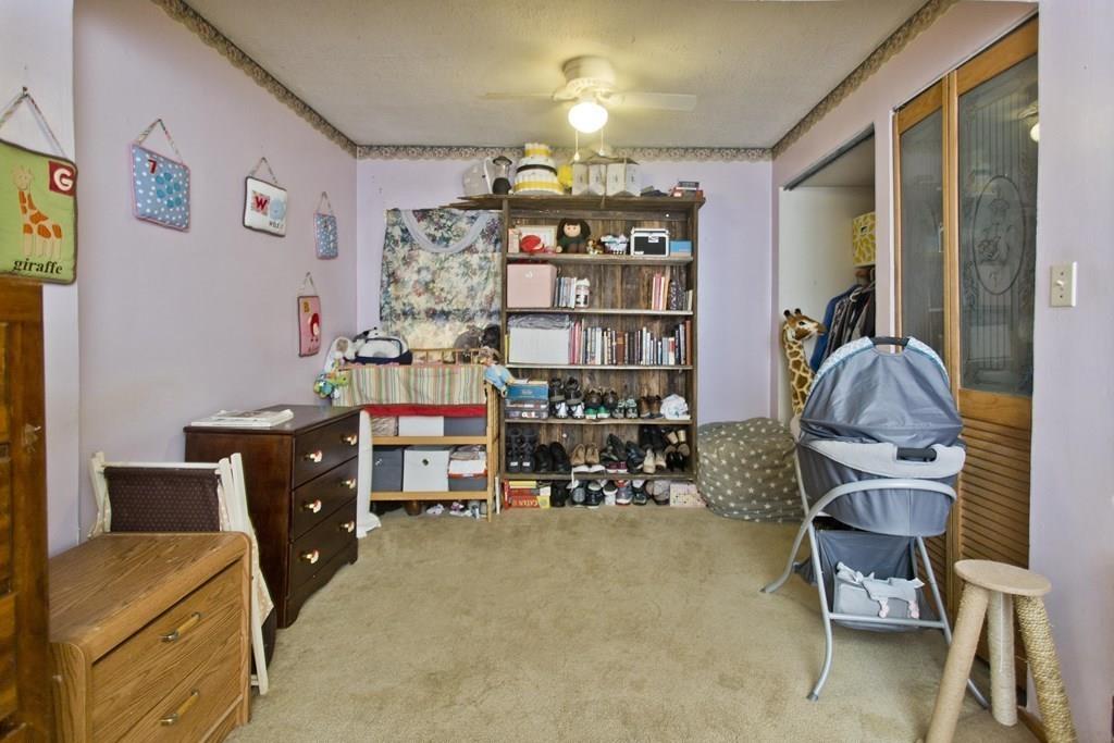 91 Penrose Street Springfield, MA 01109 - Photo 8 of 23 a work room with furniture and a chandelier