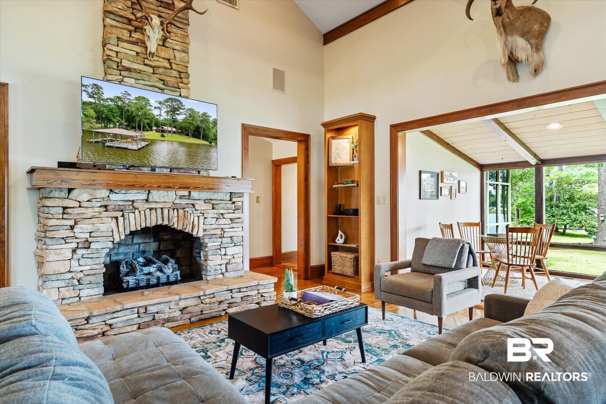 2228 Riverside Drive Mobile, AL 36605 - Photo 13 of 51 Living room featuring hardwood / wood-style floors, a stone fireplace, high vaulted ceiling, and beamed ceiling