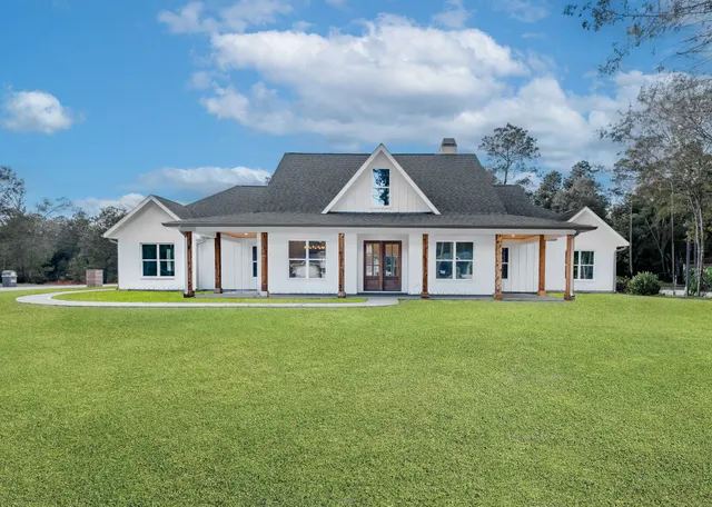 a view of a big yard with a house in the background