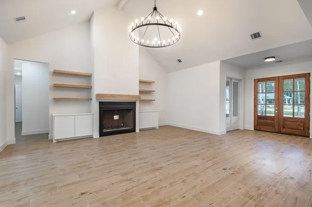 an empty room with a fireplace and window