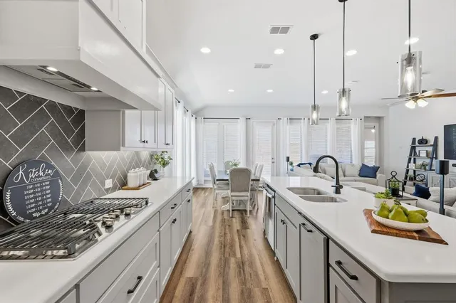 a kitchen with counter top space a sink and appliances